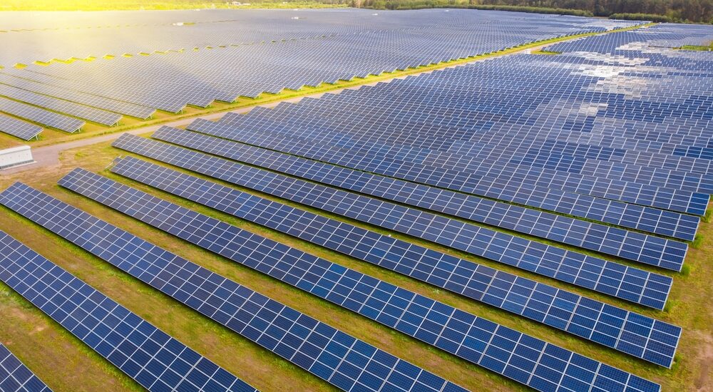 Aerial view to solar power plant. Industrial background on renewable resources theme.